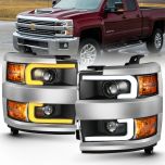 AmeriLite for 2015-2019 Silverado 2500HD 3500HD Pickup w/Dual Switchback LED Tube Quad Projector Black Replacement Headlights Assembly Set - Passenger and Driver Side